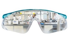 Lab safety glasses reflecting lab bench and scientists