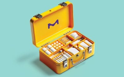 Vibrant yellow first aid kit with lid open to reveal its contents of  wound healing tools represents Merck's innovative polymers and biocompatible products for wound dressing solutions.