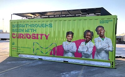 Curiosity Cube, a brightly colored shipping container used for science experiments.