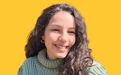 Headshot of Nisan Irem Ceting&ouml;k on a vibrant yellow background