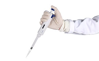 Gloved hand holding pipette to add purified water or PBS to antibody vial.